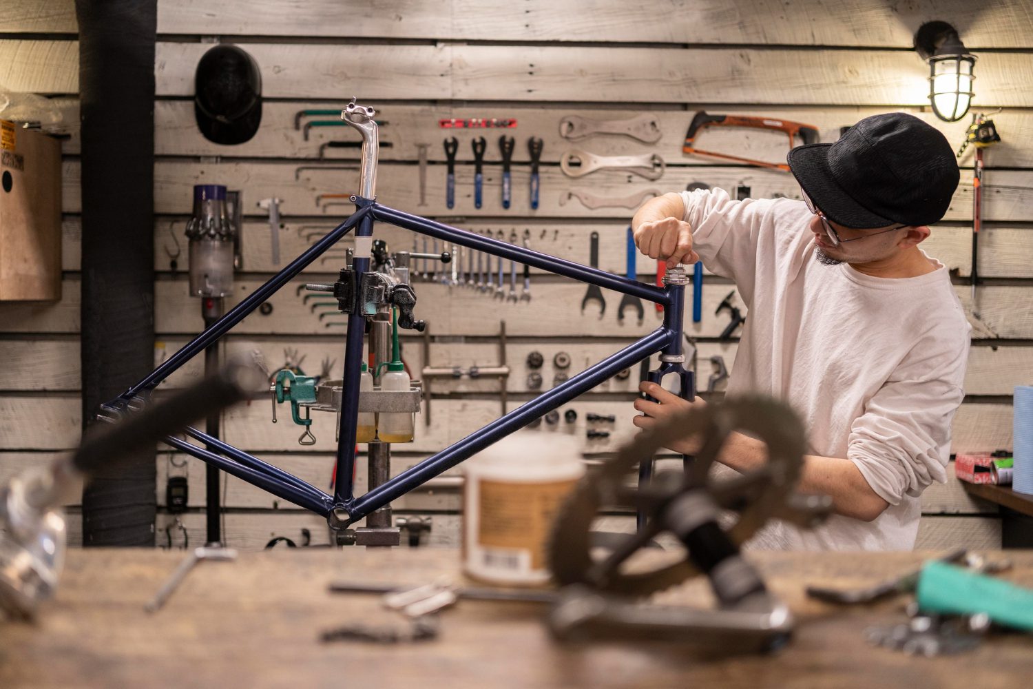 medium-shot-man-repairing-bike (1) medium shot man repairing bike